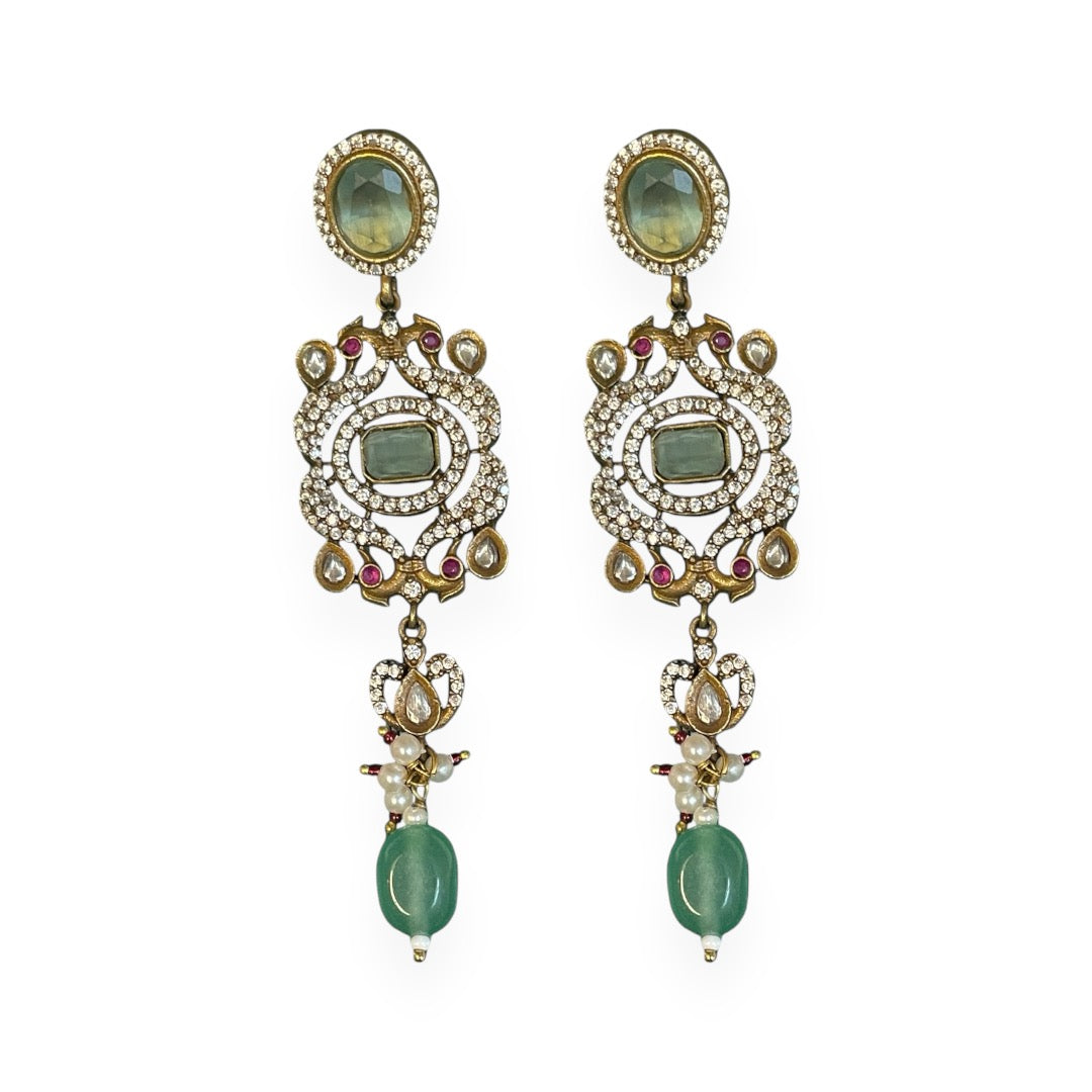 The graceful drop bead adds movement and fluidity, embodying Annetta’s daring spirit and acrobatic elegance. The green jade symbolizes vitality and renewal, while the luxurious gold adds timeless sophistication. Inspired by Annetta’s extraordinary talents and captivating allure, these earrings capture the perfect balance of romantic artistry, feminine strength, and Parisian glamour.