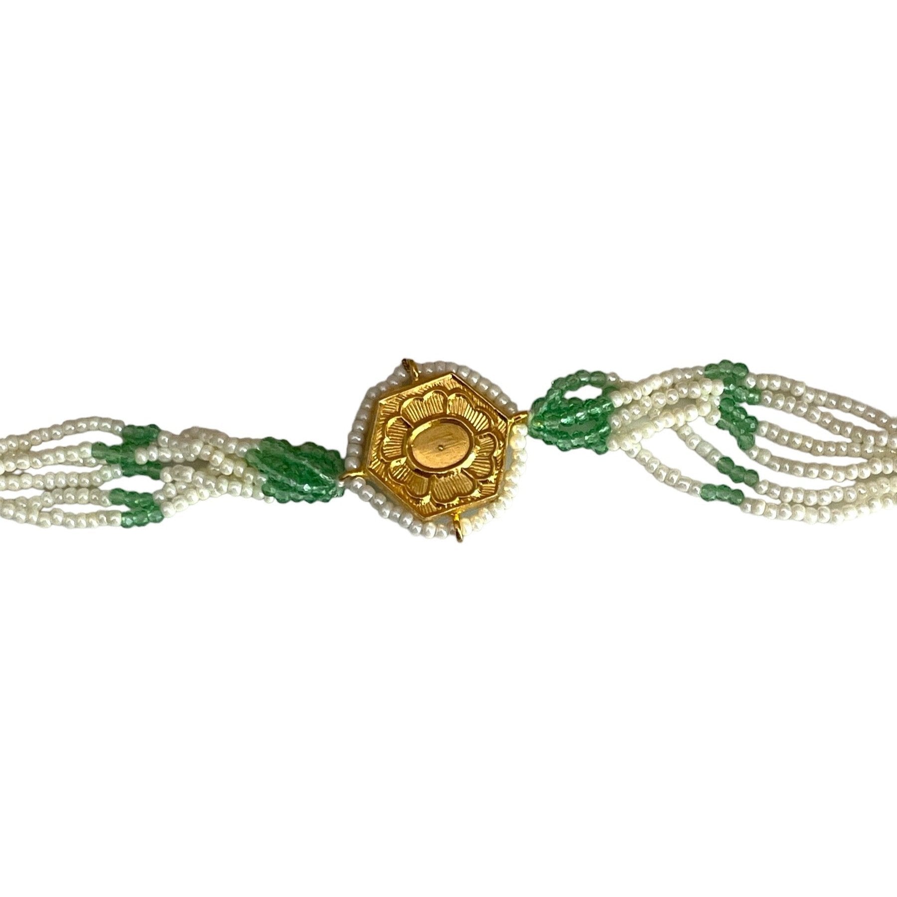 The Marguerite Bracelet features a bold hexagonal shape, surrounded by delicate Kundan stones and lustrous pearls. Elegant green enamel hand-painted to perfection brings a striking contrast to the bracelet, while green and white chains on either side create a harmonious balance of color and texture.