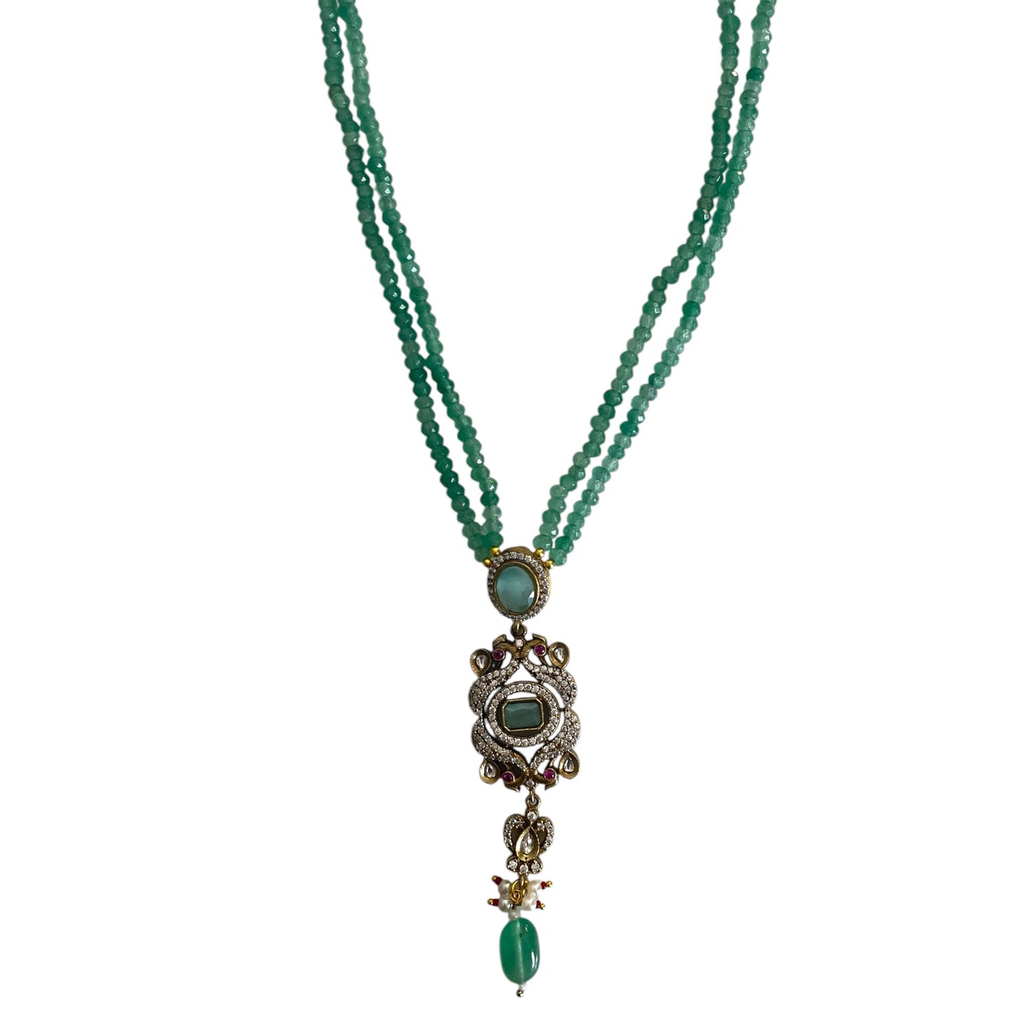 Introducing the Rose Necklace, a stunning homage to Édith Piaf’s timeless love song La vie en rose, where elegance meets artistic expression. This luxurious long necklace features a striking rectangular pendant adorned with kundan stones and gold accents, evoking a sense of romantic sophistication and Parisian charm. The pendant’s unique design, with a delicate drop bead, adds fluidity and grace, symbolizing the endless beauty of love. The rich green jade represents vitality and renewal, while the radiant g