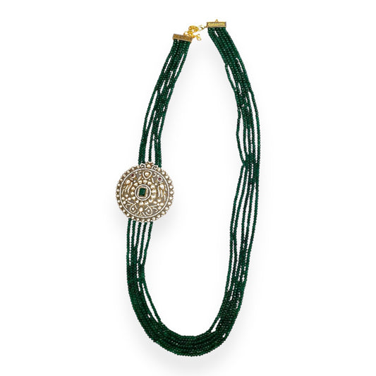 Introducing the Édith Necklace, a captivating fusion of elegance and bold artistry, named in honor of the iconic Édith Piaf. This luxurious necklace features a round pendant crafted with a stunning green jade stone necklace, framed in 18k gold dipped vintage elegance to evoke timeless Parisian glamour. Worn off-center, like an elegant brooch, the pendant creates a striking, asymmetrical silhouette that drapes with effortless grace, offering a fresh twist on classic jewelry.
