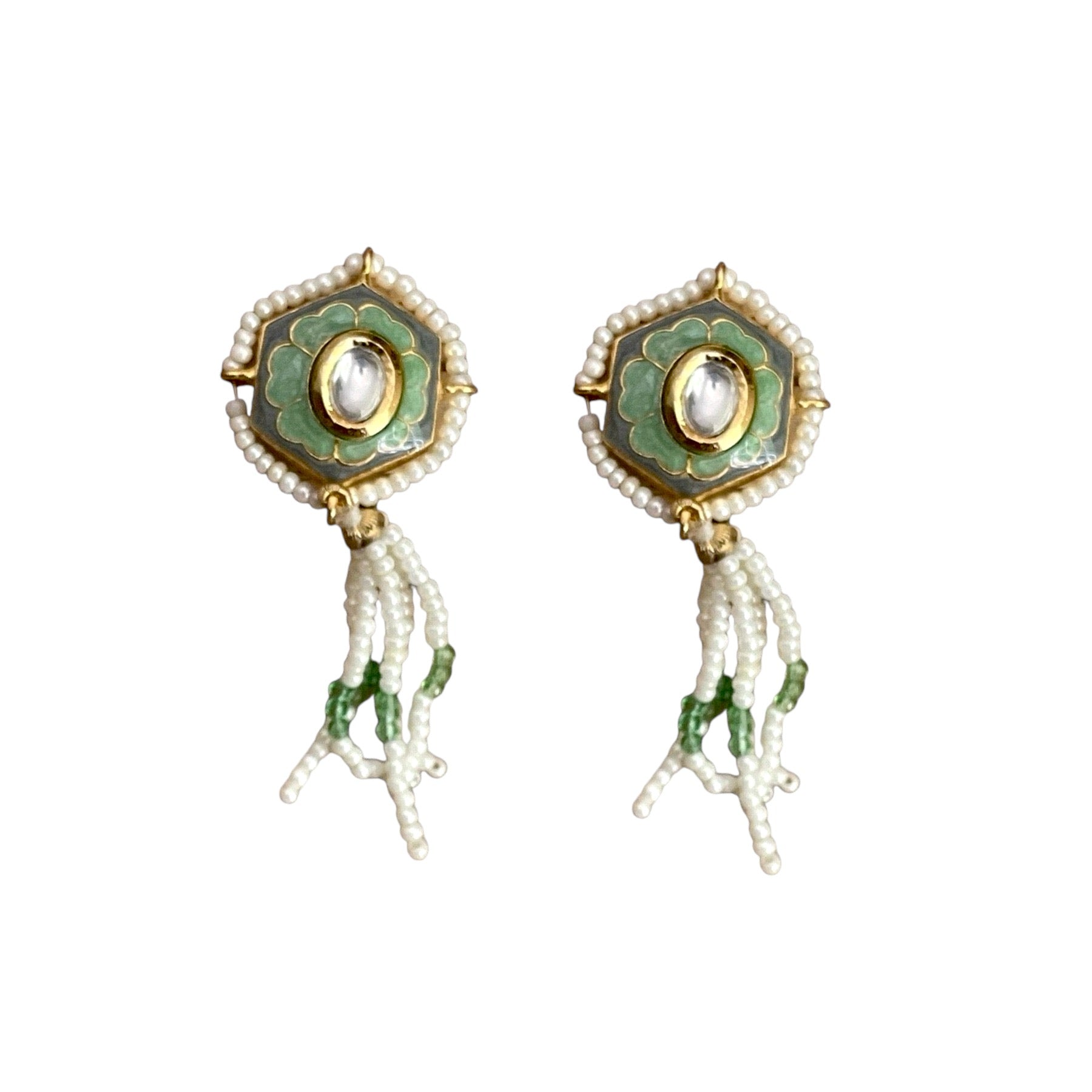 Irma Earrings are a stunning fusion of timeless craftsmanship and contemporary elegance. These earrings feature a bold hexagonal shape, adorned with luxurious green enamel and intricate Kundan stones, creating a captivating interplay of light and color.