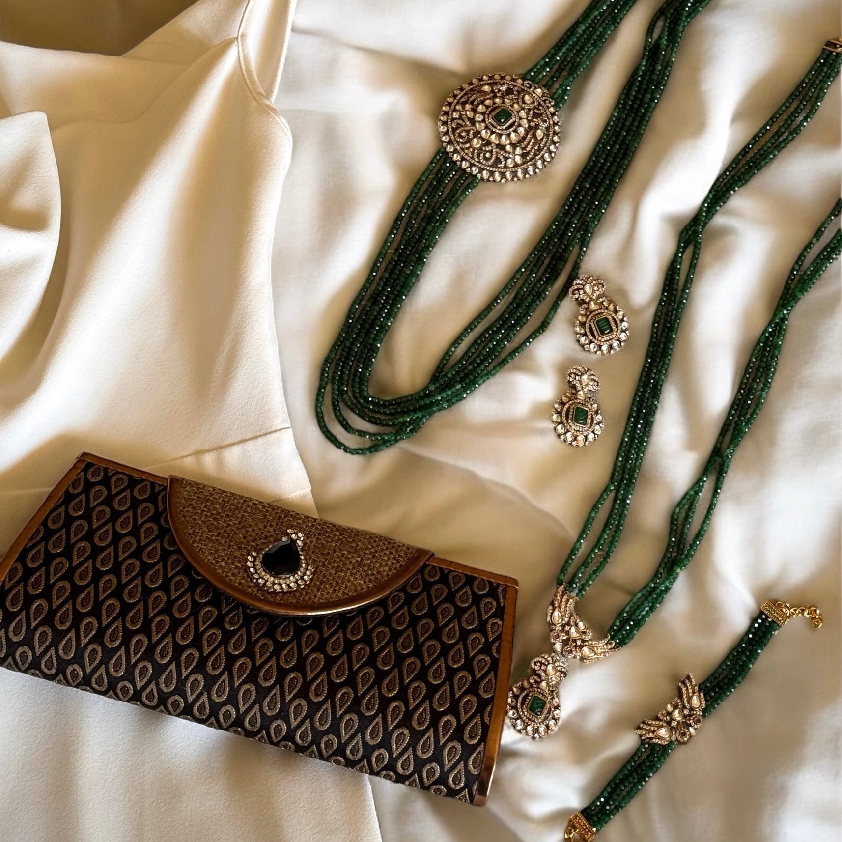 Introducing the Jane Earrings, a dazzling homage to the iconic Can-can dancer Jane Avril and the spirited elegance of Parisian cabaret. These exquisite earrings feature a stunning green center stone, surrounded by a delicate halo of Kundan stones and set in 18k gold dipped vintage vibe.