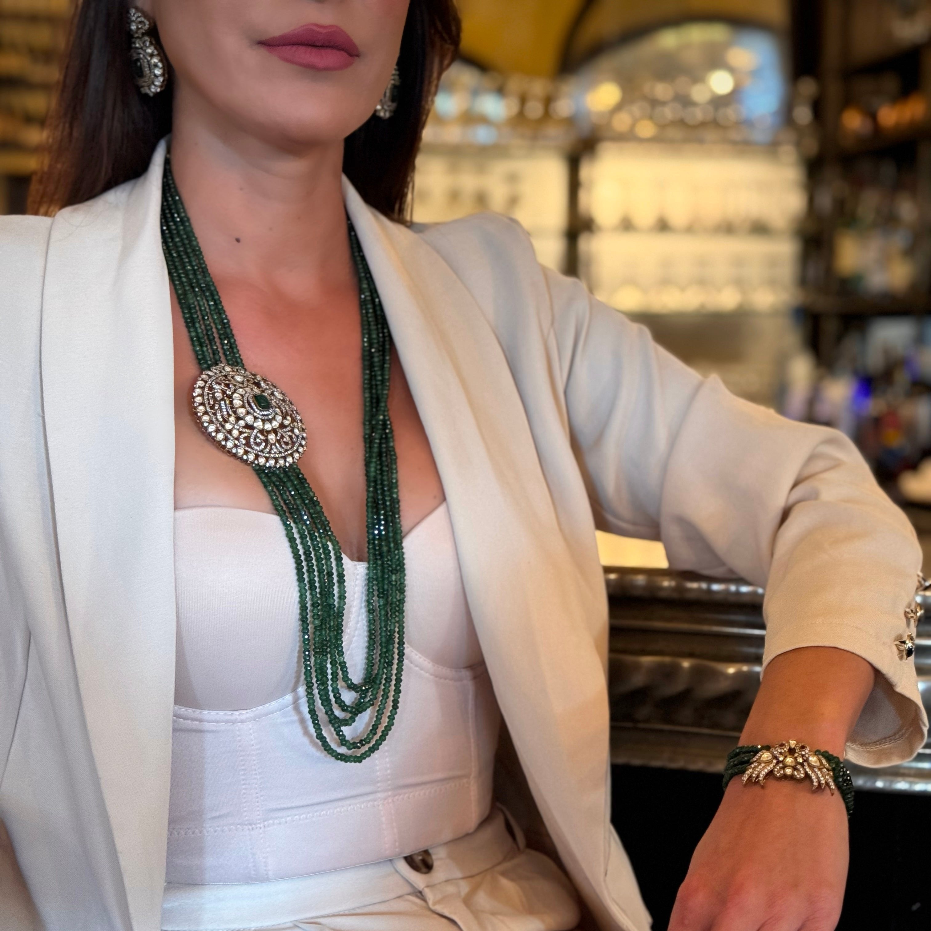 Introducing the Édith Necklace, a captivating fusion of elegance and bold artistry, named in honor of the iconic Édith Piaf. This luxurious necklace features a round pendant crafted with a stunning green jade stone necklace, framed in 18k gold dipped vintage elegance to evoke timeless Parisian glamour. Worn off-center, like an elegant brooch, the pendant creates a striking, asymmetrical silhouette that drapes with effortless grace, offering a fresh twist on classic jewelry.