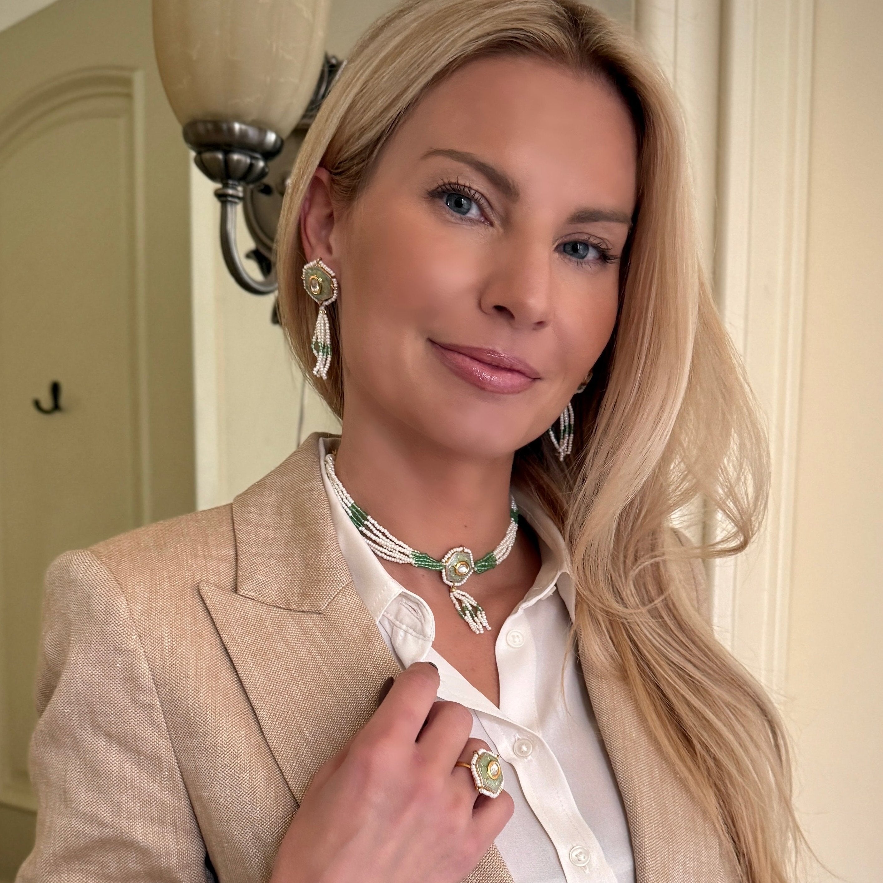 Irma Earrings are a stunning fusion of timeless craftsmanship and contemporary elegance. These earrings feature a bold hexagonal shape, adorned with luxurious green enamel and intricate Kundan stones, creating a captivating interplay of light and color.