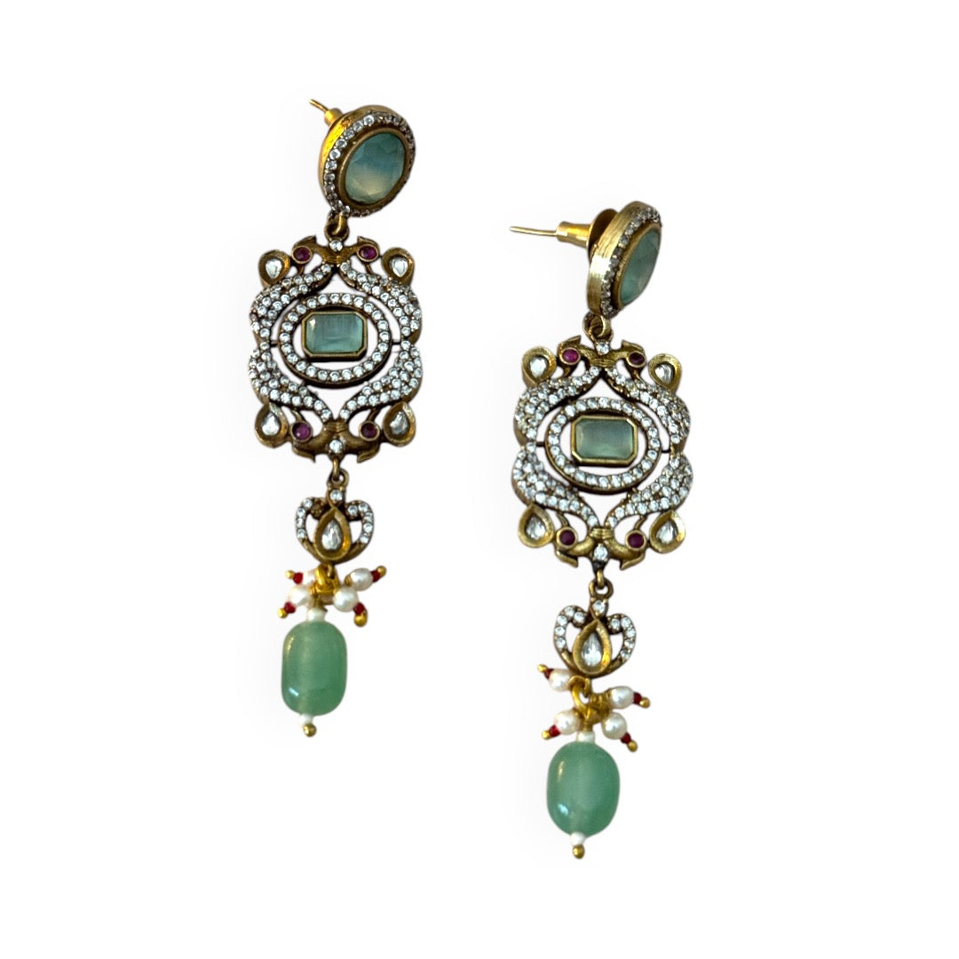 The graceful drop bead adds movement and fluidity, embodying Annetta’s daring spirit and acrobatic elegance. The green jade symbolizes vitality and renewal, while the luxurious gold adds timeless sophistication. Inspired by Annetta’s extraordinary talents and captivating allure, these earrings capture the perfect balance of romantic artistry, feminine strength, and Parisian glamour.