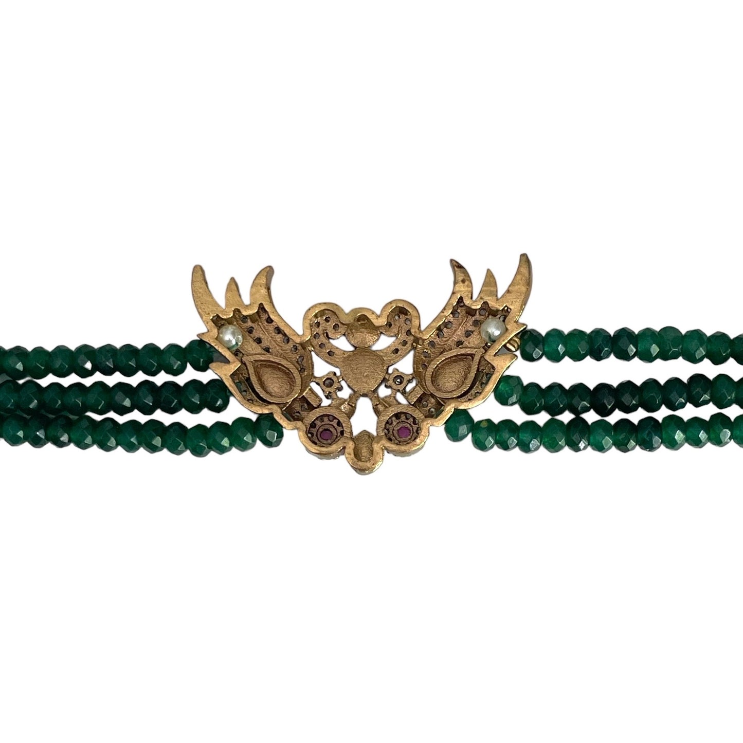 Introducing the Rita Bracelet, a stunning fusion of avant-garde elegance and Parisian flair. Inspired by the bold, rebellious spirit of the iconic French duo Les Rita Mitsouko, this bracelet features luminous jade beads and sparkling Kundan stones in a captivating green and gold palette with a hint of red. Designed to evoke the graceful, powerful movement of wings, it captures the essence of freedom, creativity, and unforgettable style.