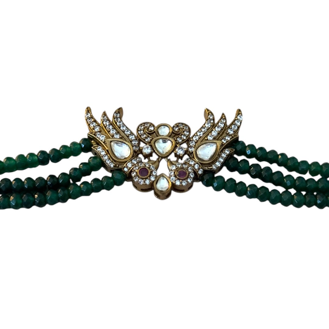 Introducing the Rita Bracelet, a stunning fusion of avant-garde elegance and Parisian flair. Inspired by the bold, rebellious spirit of the iconic French duo Les Rita Mitsouko, this bracelet features luminous jade beads and sparkling Kundan stones in a captivating green and gold palette with a hint of red. Designed to evoke the graceful, powerful movement of wings, it captures the essence of freedom, creativity, and unforgettable style.