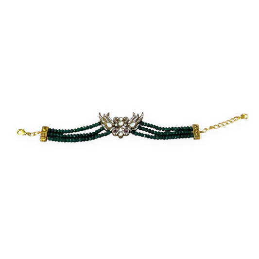 Introducing the Rita Bracelet, a stunning fusion of avant-garde elegance and Parisian flair. Inspired by the bold, rebellious spirit of the iconic French duo Les Rita Mitsouko, this bracelet features luminous jade beads and sparkling Kundan stones in a captivating green and gold palette with a hint of red. Designed to evoke the graceful, powerful movement of wings, it captures the essence of freedom, creativity, and unforgettable style.