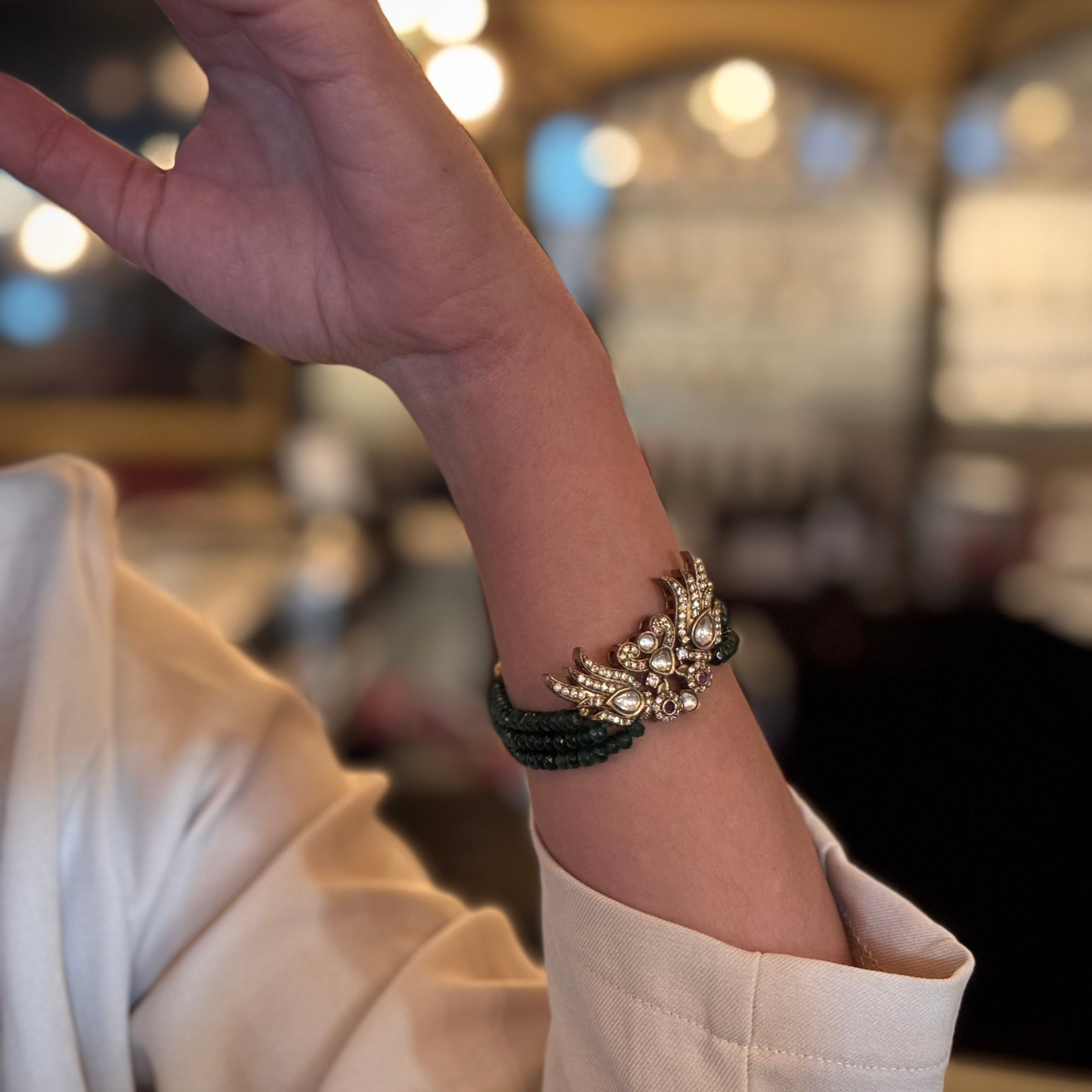 Introducing the Rita Bracelet, a stunning fusion of avant-garde elegance and Parisian flair. Inspired by the bold, rebellious spirit of the iconic French duo Les Rita Mitsouko, this bracelet features luminous jade beads and sparkling Kundan stones in a captivating green and gold palette with a hint of red. Designed to evoke the graceful, powerful movement of wings, it captures the essence of freedom, creativity, and unforgettable style.