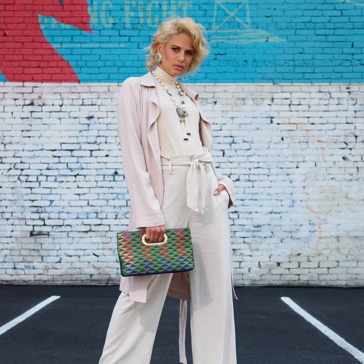 Model wearing Maheswary collection turquoise earrings and baroque pearl necklace with multi color Gaja tote. Rani Collection as seen at NYFW 2021 Flying solo by Veronica Tharmalingam