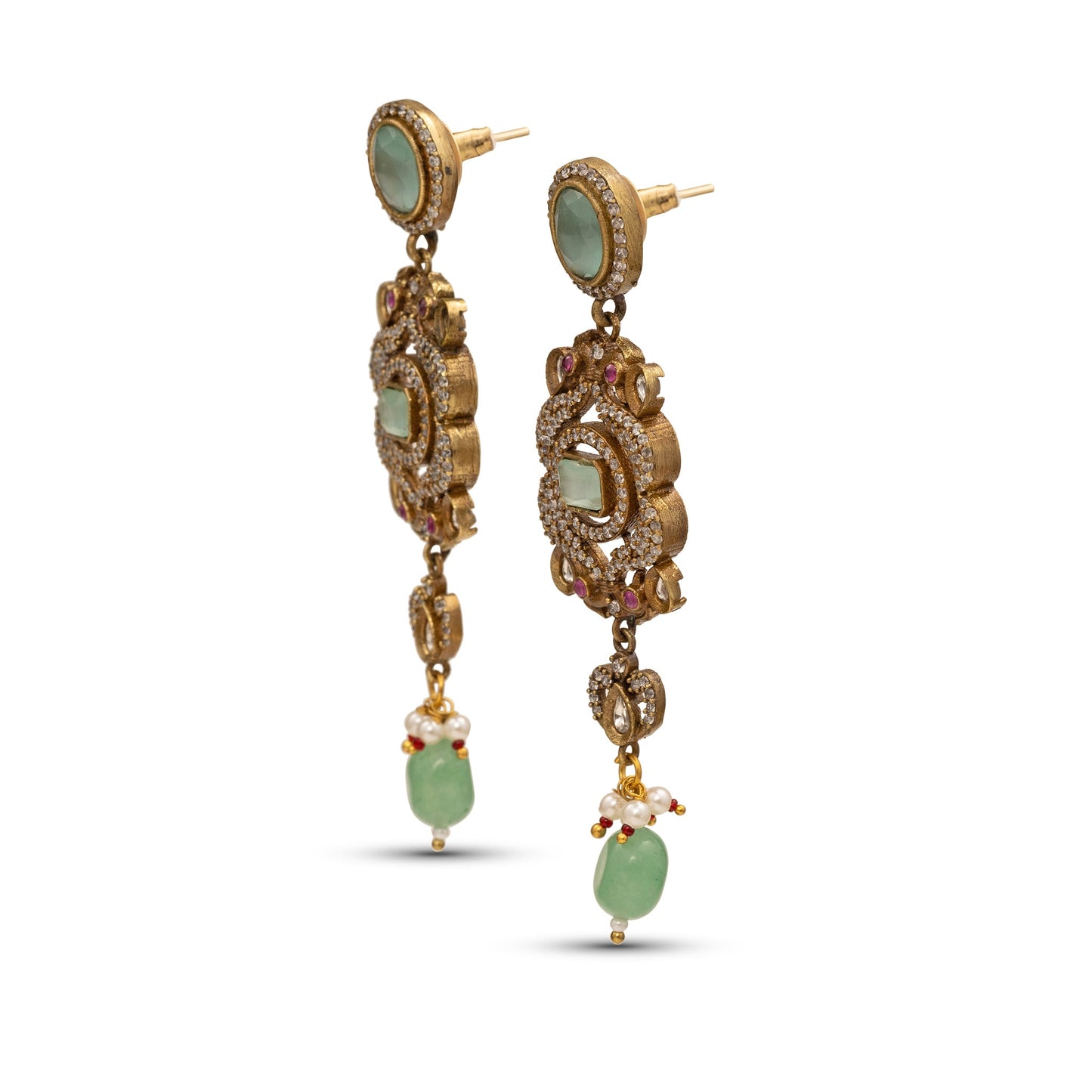 Gold earrings with green gemstones on a white background