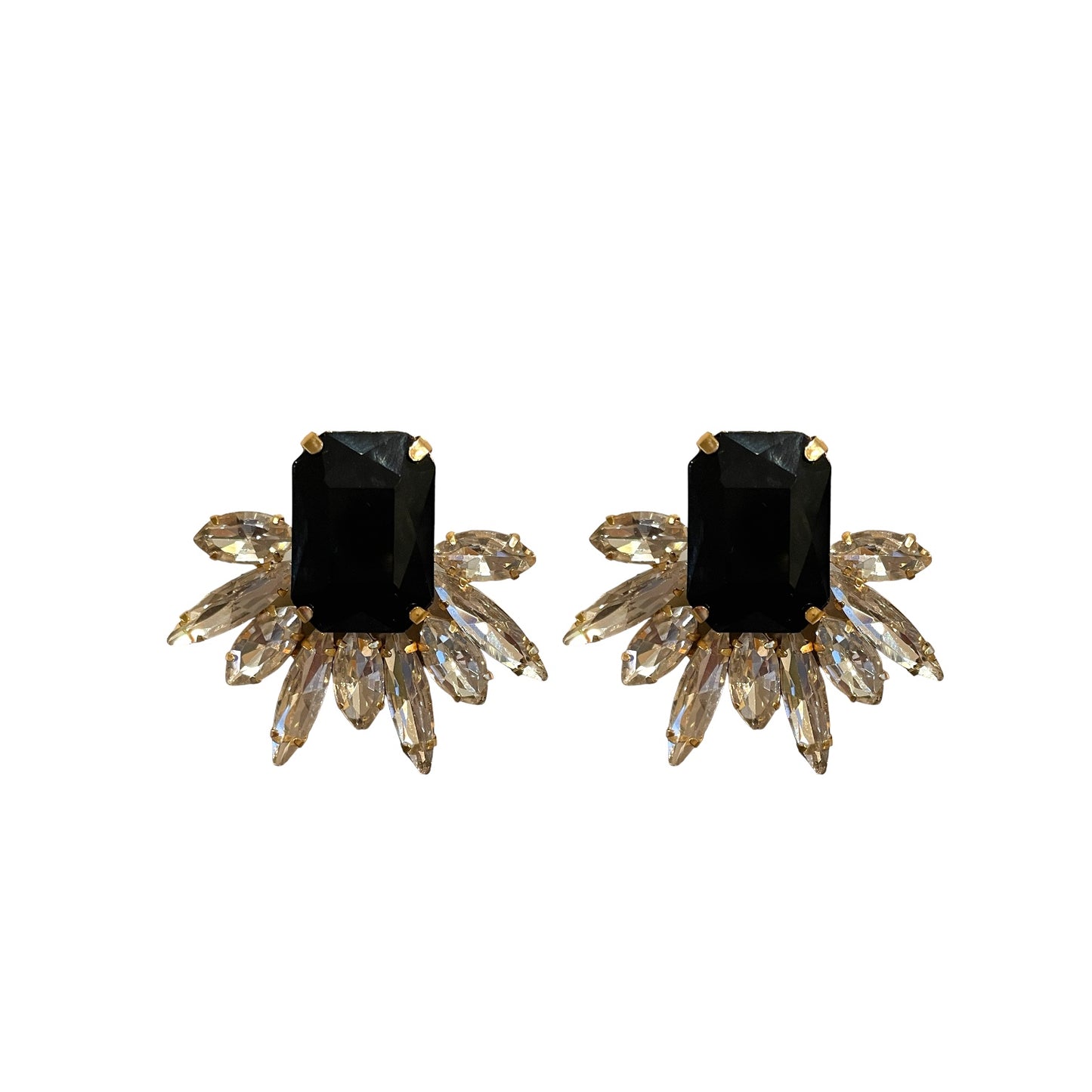 Pair of earrings with black gemstones and gold accents on a white background