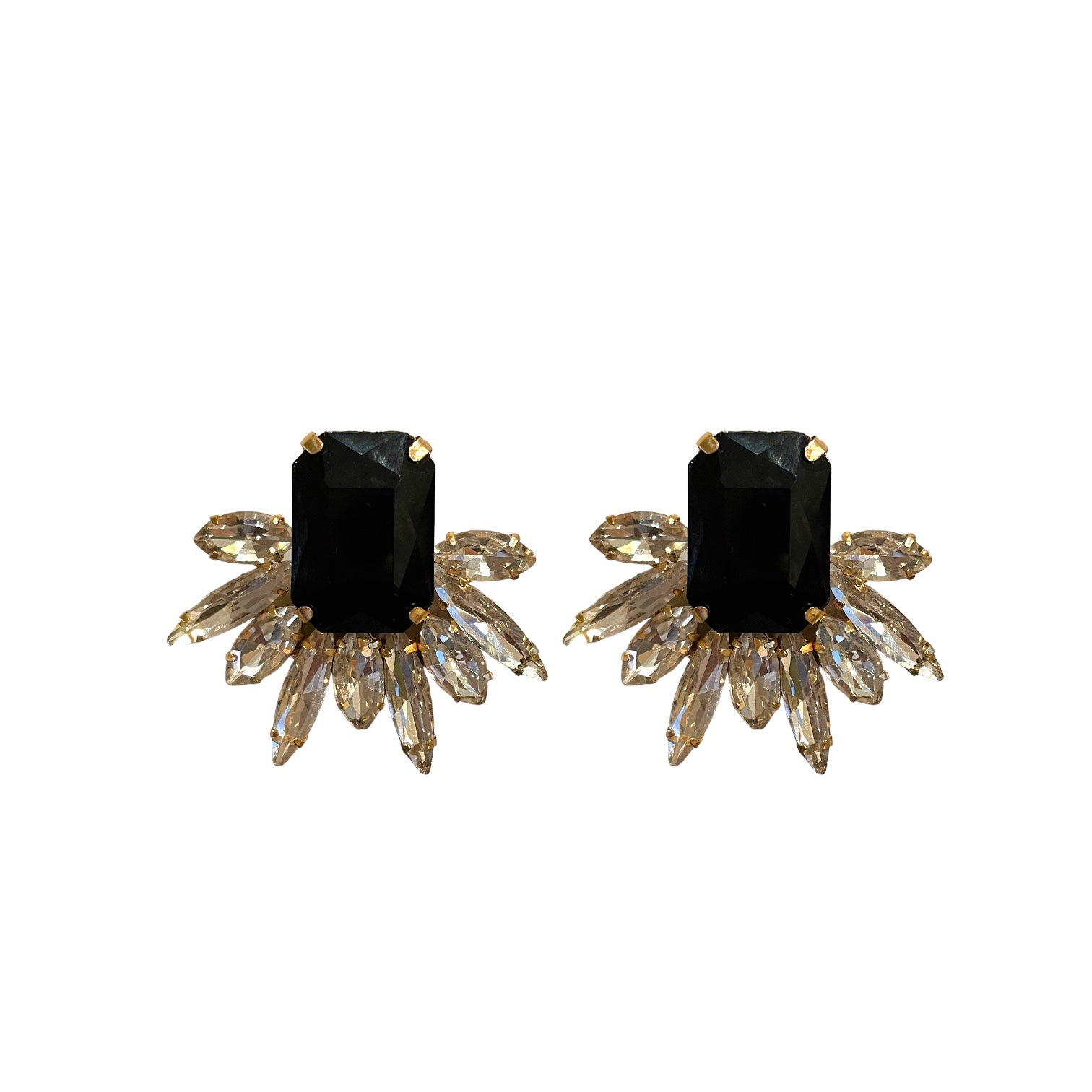 Pair of earrings with black gemstones and gold accents on a white background
