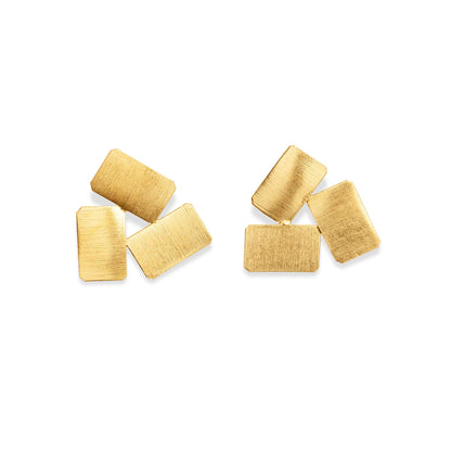 Pair of gold earrings on a white background