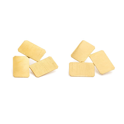 Gold rectangular made into triangle shapes earrings on a white background