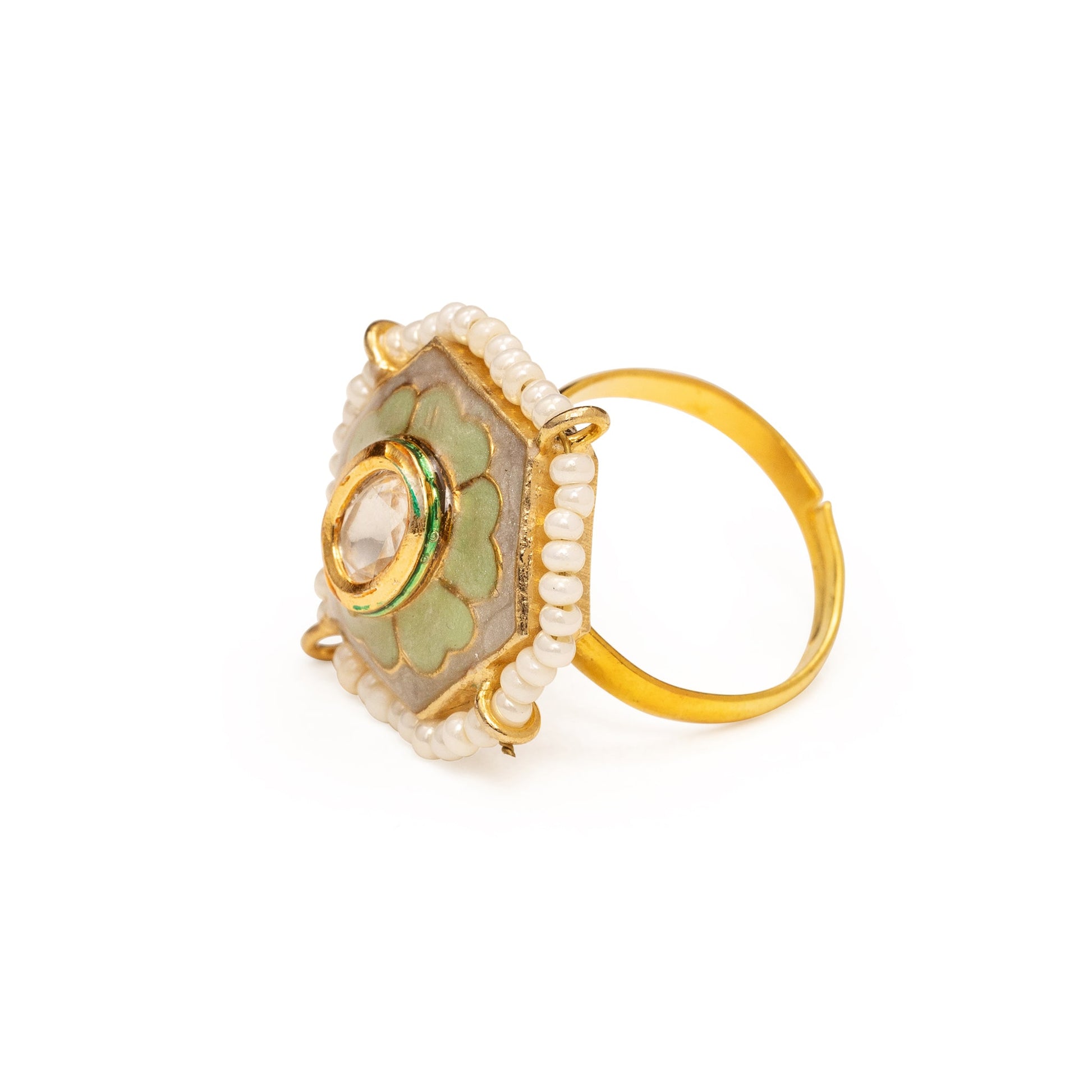 Gold ring with green gemstone and pearl-like beads on a white background