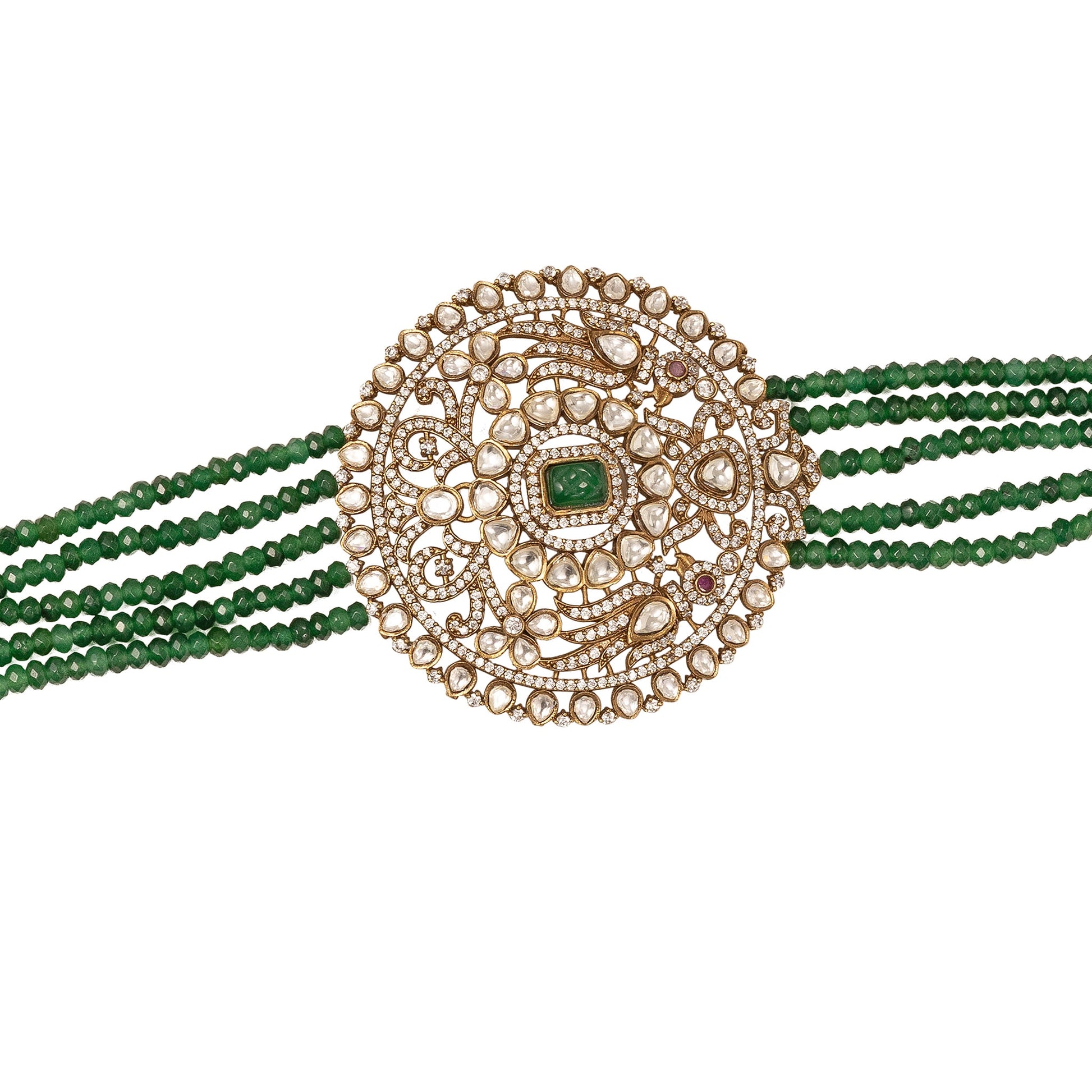 Decorative neckalce with gold circular design and green beads on a white background