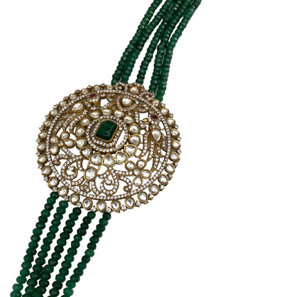 Introducing the Édith Necklace, a captivating fusion of elegance and bold artistry, named in honor of the iconic Édith Piaf. This luxurious necklace features a round pendant crafted with a stunning green jade stone necklace, framed in 18k gold dipped vintage elegance to evoke timeless Parisian glamour. Worn off-center, like an elegant brooch, the pendant creates a striking, asymmetrical silhouette that drapes with effortless grace, offering a fresh twist on classic jewelry.