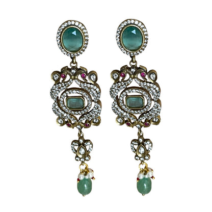 The graceful drop bead adds movement and fluidity, embodying Annetta’s daring spirit and acrobatic elegance. The green jade symbolizes vitality and renewal, while the luxurious gold adds timeless sophistication. Inspired by Annetta’s extraordinary talents and captivating allure, these earrings capture the perfect balance of romantic artistry, feminine strength, and Parisian glamour.