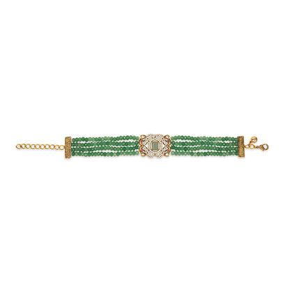 Green beaded bracelet with gold clasp on a white background