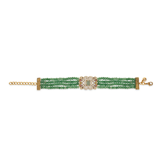 Green beaded bracelet with gold clasp on a white background