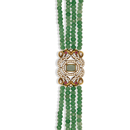 Green beaded bracelet with a decorative core on a white background