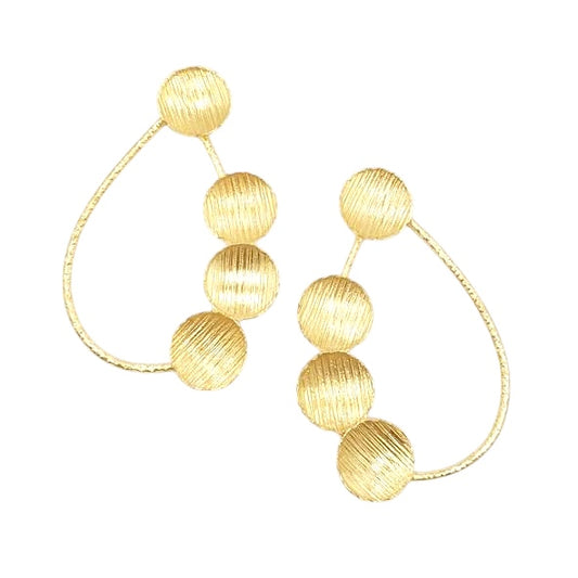 Gold hoop earrings with spherical beads on a white background