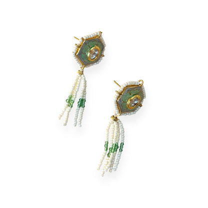 Irma Earrings are a stunning fusion of timeless craftsmanship and contemporary elegance. These earrings feature a bold hexagonal shape, adorned with luxurious green enamel and intricate Kundan stones, creating a captivating interplay of light and color. 
