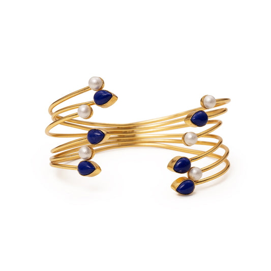 Gold bracelet with blue and white beads on a white background