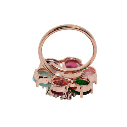Rose gold ring with colorful gemstones on a white background