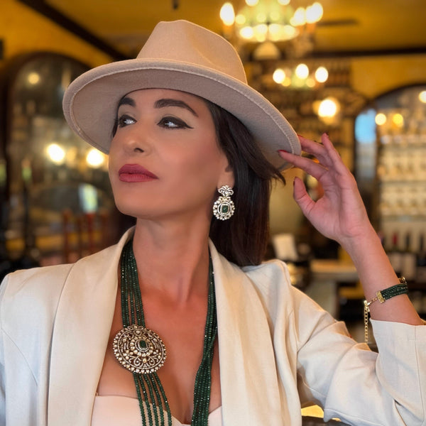 Introducing the Jane Earrings, a dazzling homage to the iconic Can-can dancer Jane Avril and the spirited elegance of Parisian cabaret. These exquisite earrings feature a stunning green center stone, surrounded by a delicate halo of Kundan stones and set in 18k gold dipped vintage vibe.