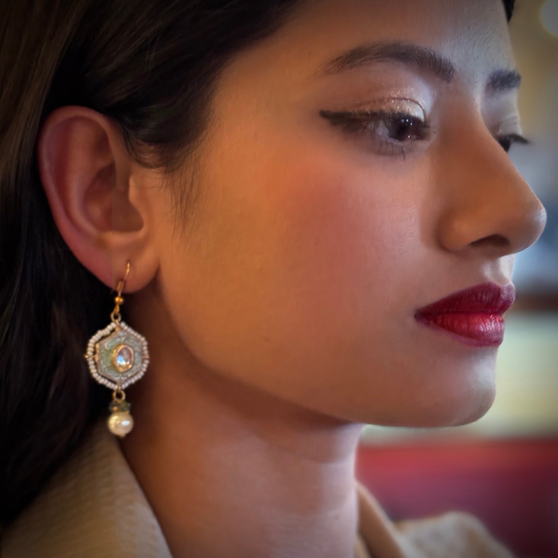 These earrings embody the free-spirited elegance and musical beauty of classic jazz. The Gypsy Earrings feature a striking hexagonal shape, with lustrous pearls dangling gracefully beneath, creating movement and light. Hand-painted green enamel adds a pop of color