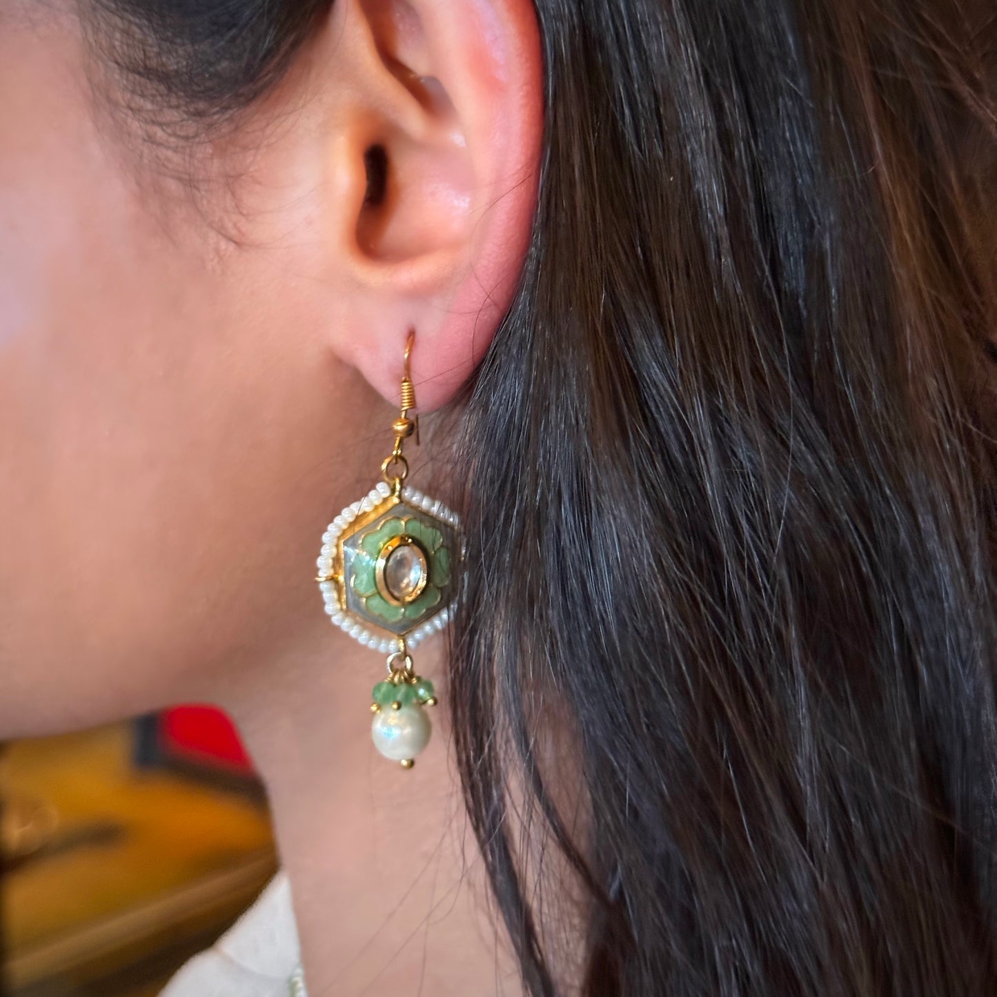 These earrings embody the free-spirited elegance and musical beauty of classic jazz. The Gypsy Earrings feature a striking hexagonal shape, with lustrous pearls dangling gracefully beneath, creating movement and light. Hand-painted green enamel adds a pop of color