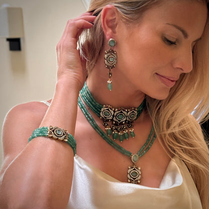 The Giovanna Bracelet is a luxurious tribute to Edith Piaf, named after her middle name, Giovanna. Handcrafted with four strands of jade beads on each side, this elegant bracelet features a rectangular center adorned with vibrant red, green, and white stones—each chosen for their symbolic meaning and energy. 
