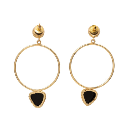 Gold hoop earrings with black heart-shaped stones on a white background