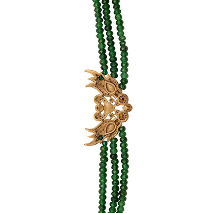 Green beaded bracelet with a gold pendant on a white background