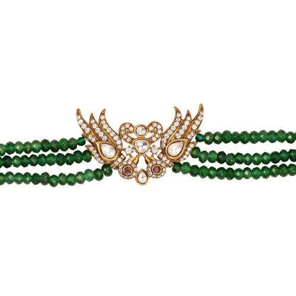 Green jade beaded bracelet with gold and gemstone clasp on a white background