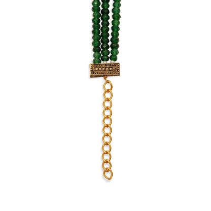 Bracelet with green beads and a gold chain on a white background