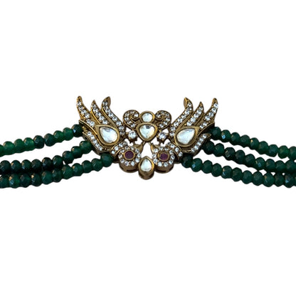 Introducing the Rita Bracelet, a stunning fusion of avant-garde elegance and Parisian flair. Inspired by the bold, rebellious spirit of the iconic French duo Les Rita Mitsouko, this bracelet features luminous jade beads and sparkling Kundan stones in a captivating green and gold palette with a hint of red. Designed to evoke the graceful, powerful movement of wings, it captures the essence of freedom, creativity, and unforgettable style. 