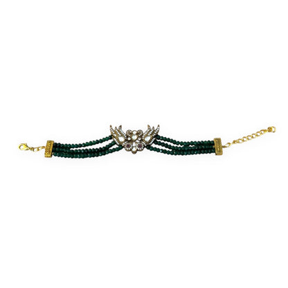 Introducing the Rita Bracelet, a stunning fusion of avant-garde elegance and Parisian flair. Inspired by the bold, rebellious spirit of the iconic French duo Les Rita Mitsouko, this bracelet features luminous jade beads and sparkling Kundan stones in a captivating green and gold palette with a hint of red. Designed to evoke the graceful, powerful movement of wings, it captures the essence of freedom, creativity, and unforgettable style. 