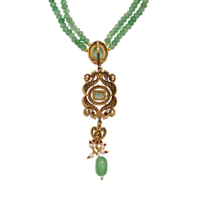 Necklace with green beads and gold pendant on a white background