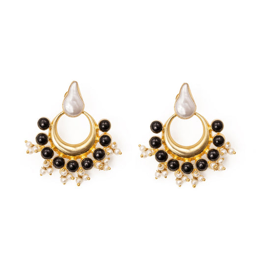 Pair of gold and black earrings on a white background